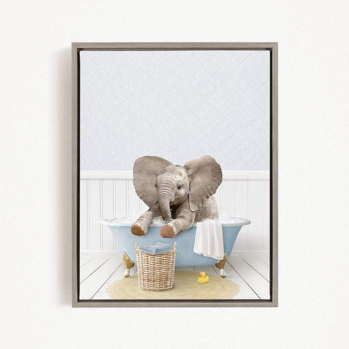 A gray elephant sitting in a blue bathtub, surrounded by a yellow rubber duck and a basket.