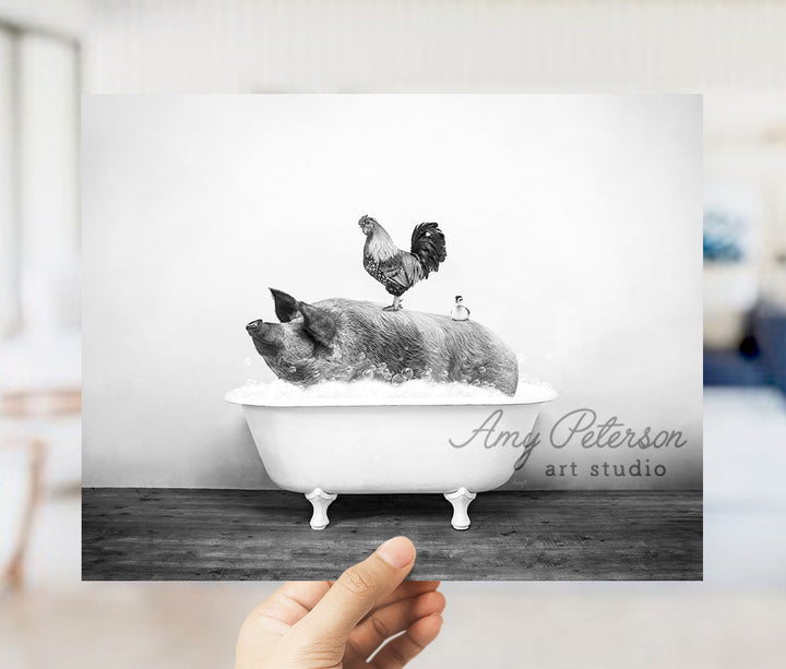 a black and white photo of two pigs in a bathtub