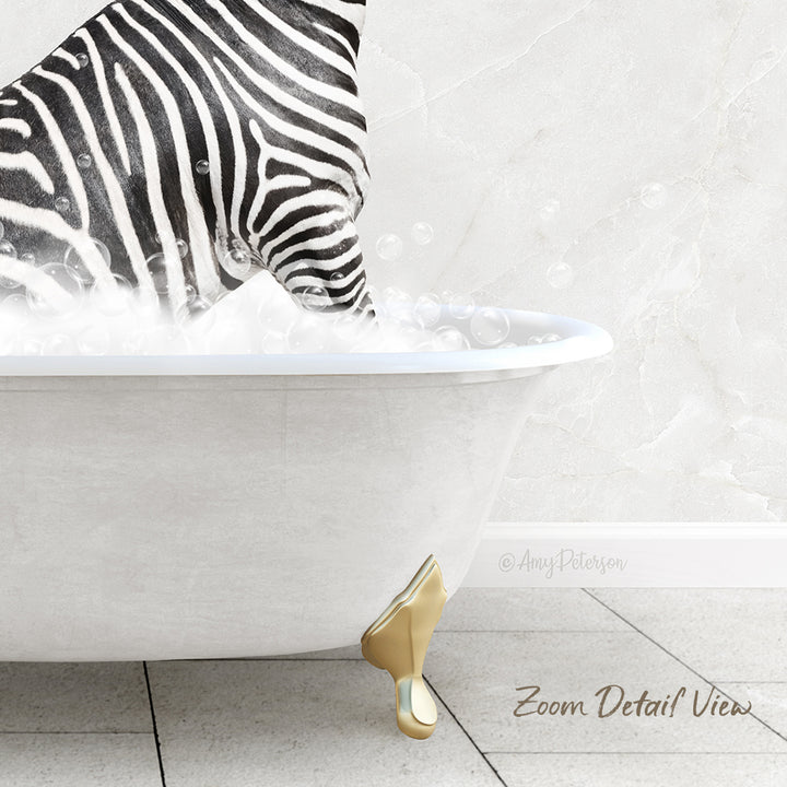 A zebra standing in a white bathtub filled with bubbles, with a gold-colored claw visible on the side of the tub.