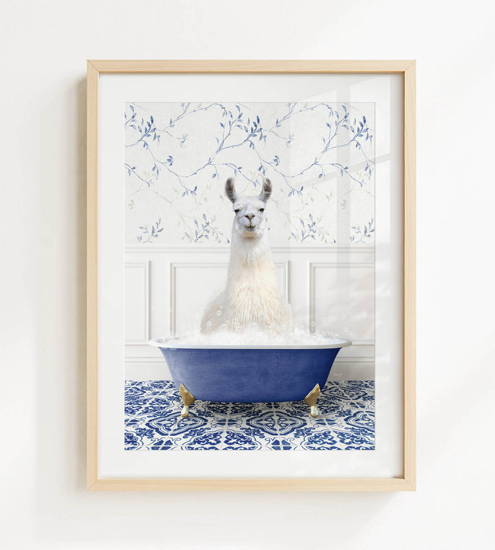 A white llama sitting in a blue bathtub filled with bubbles, surrounded by a blue and white patterned tile floor.
