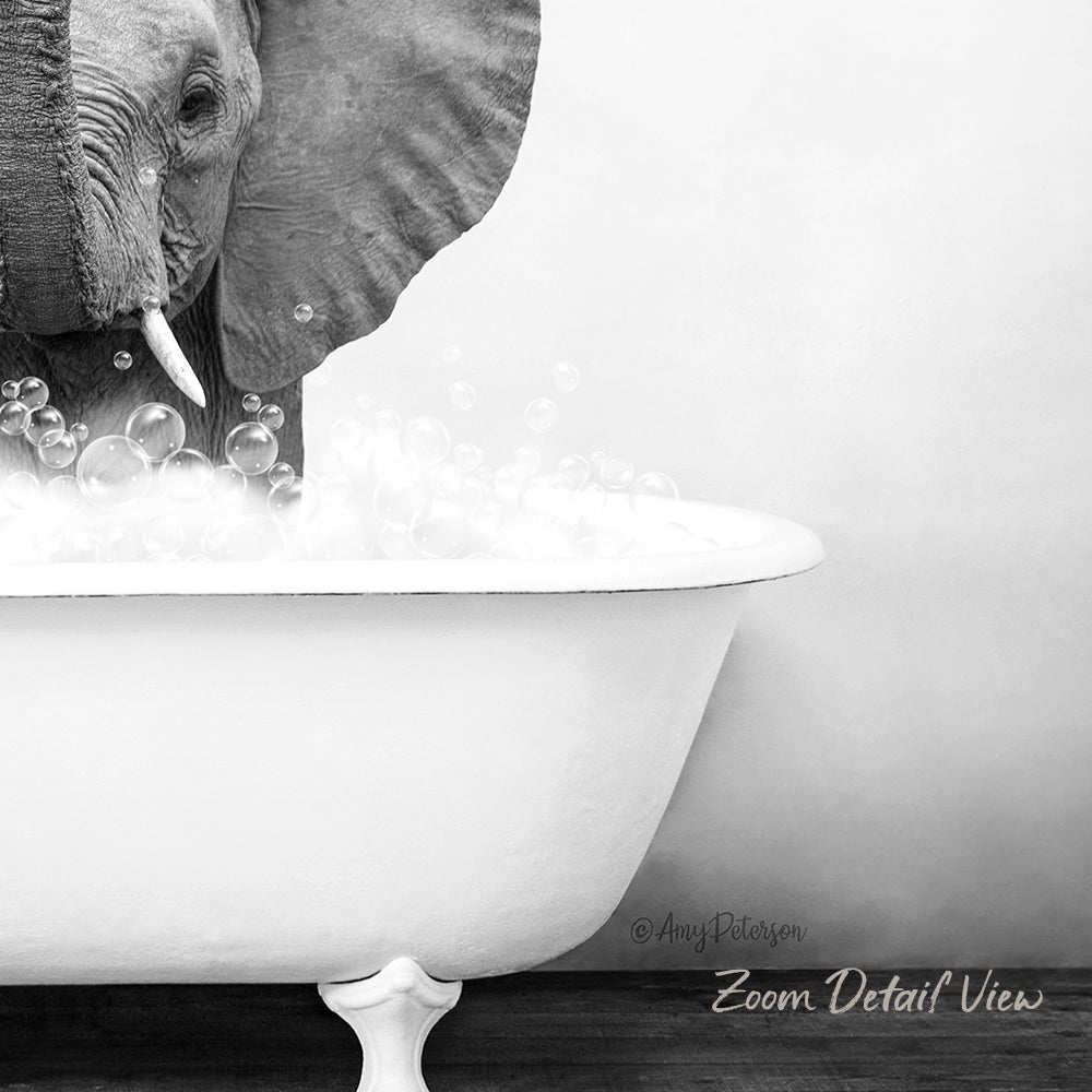 A black and white image of an elephant standing in a bathtub filled with bubbles.