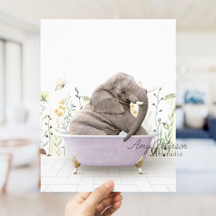 a person holding up a card with an elephant in a bathtub