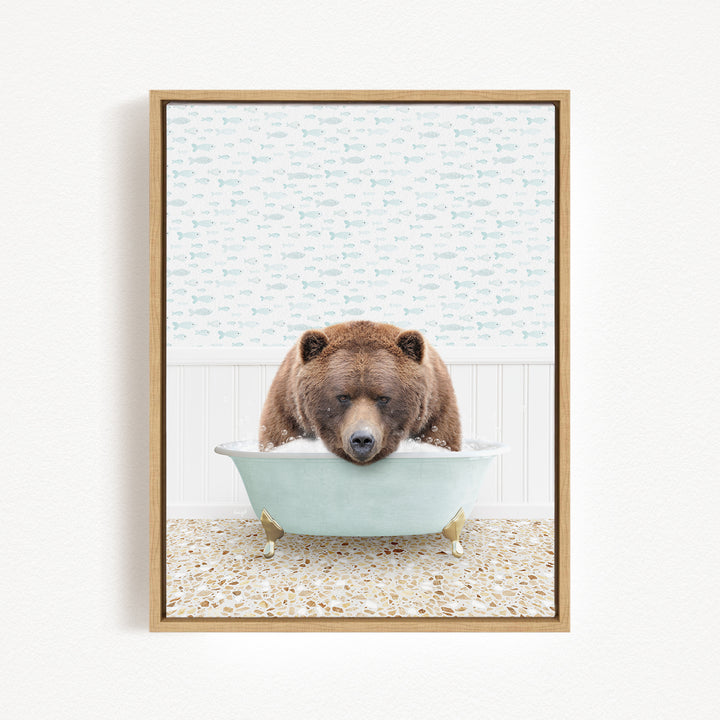 A brown bear is sitting in a light blue bathtub, surrounded by a patterned wall and a tiled floor.