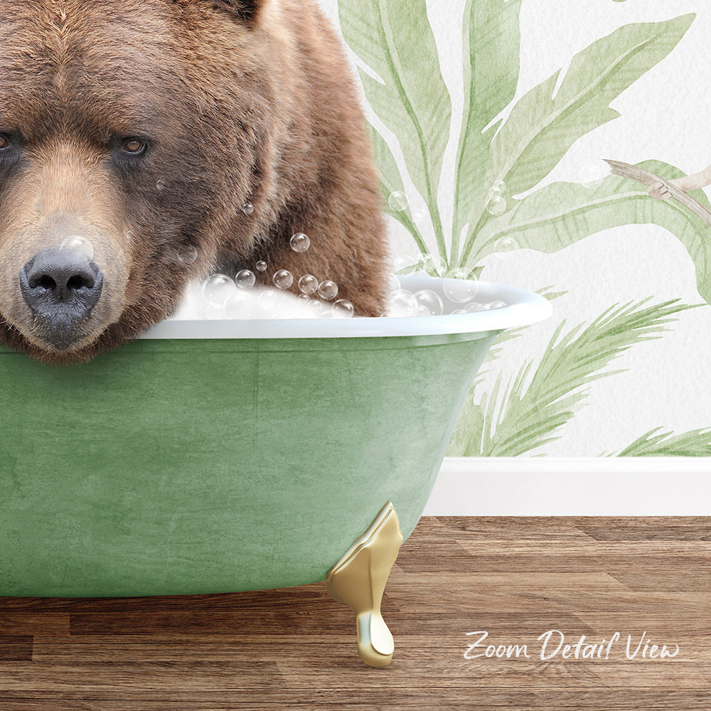 A brown bear is sitting in a green bathtub filled with bubbles, with a tropical plant design on the wall behind it.