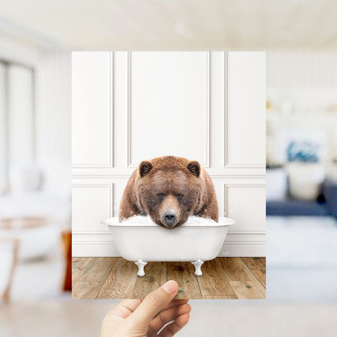 A brown bear is sitting in a white bathtub, appearing to be enjoying a relaxing bath.