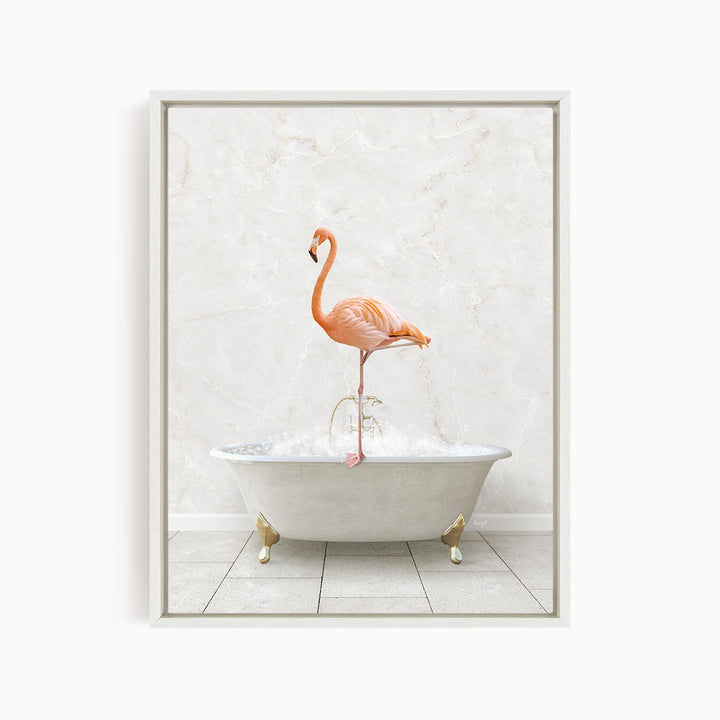 A pink flamingo standing on the edge of a white bathtub filled with bubbles.