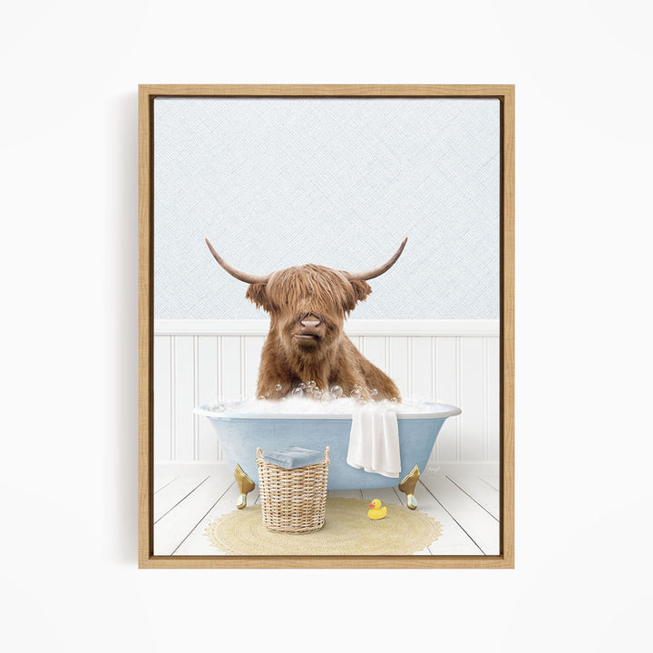A brown cow with long horns is sitting in a blue bathtub filled with water, surrounded by rubber ducks.