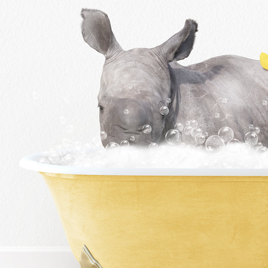 a rhino in a bathtub with bubbles and a rubber duck