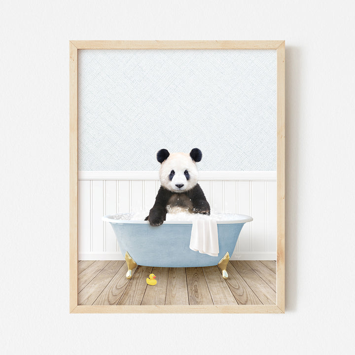 a panda bear sitting in a blue bath tub