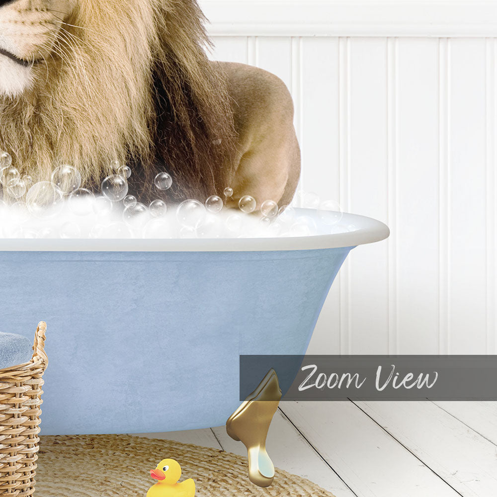 A lion is sitting in a blue bathtub filled with bubbles, surrounded by a yellow rubber duck and a basket.