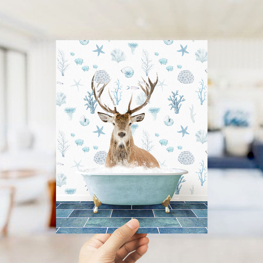 A deer with antlers is sitting in a bathtub filled with bubbles, surrounded by a pattern of blue and white seashells and starfish.