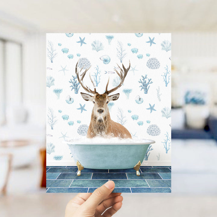 A deer with antlers is sitting in a bathtub filled with bubbles, surrounded by a pattern of blue and white seashells and starfish.