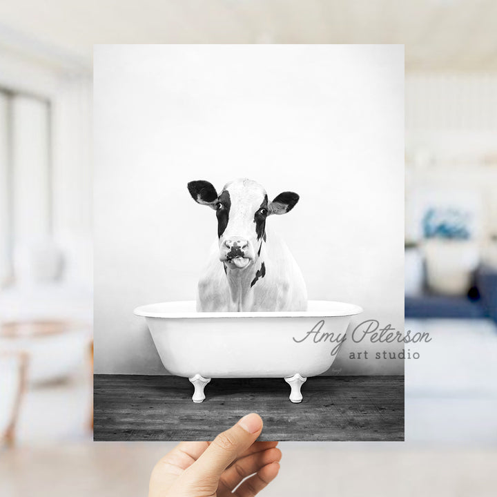 a black and white photo of a cow in a bathtub