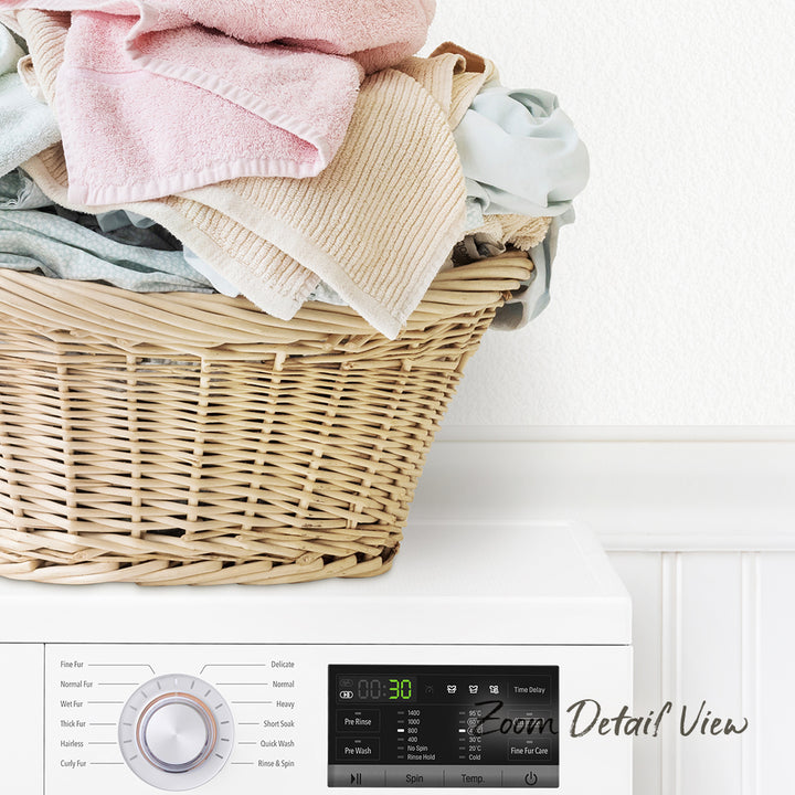 A wicker laundry basket filled with clothes sits on top of a white washing machine.