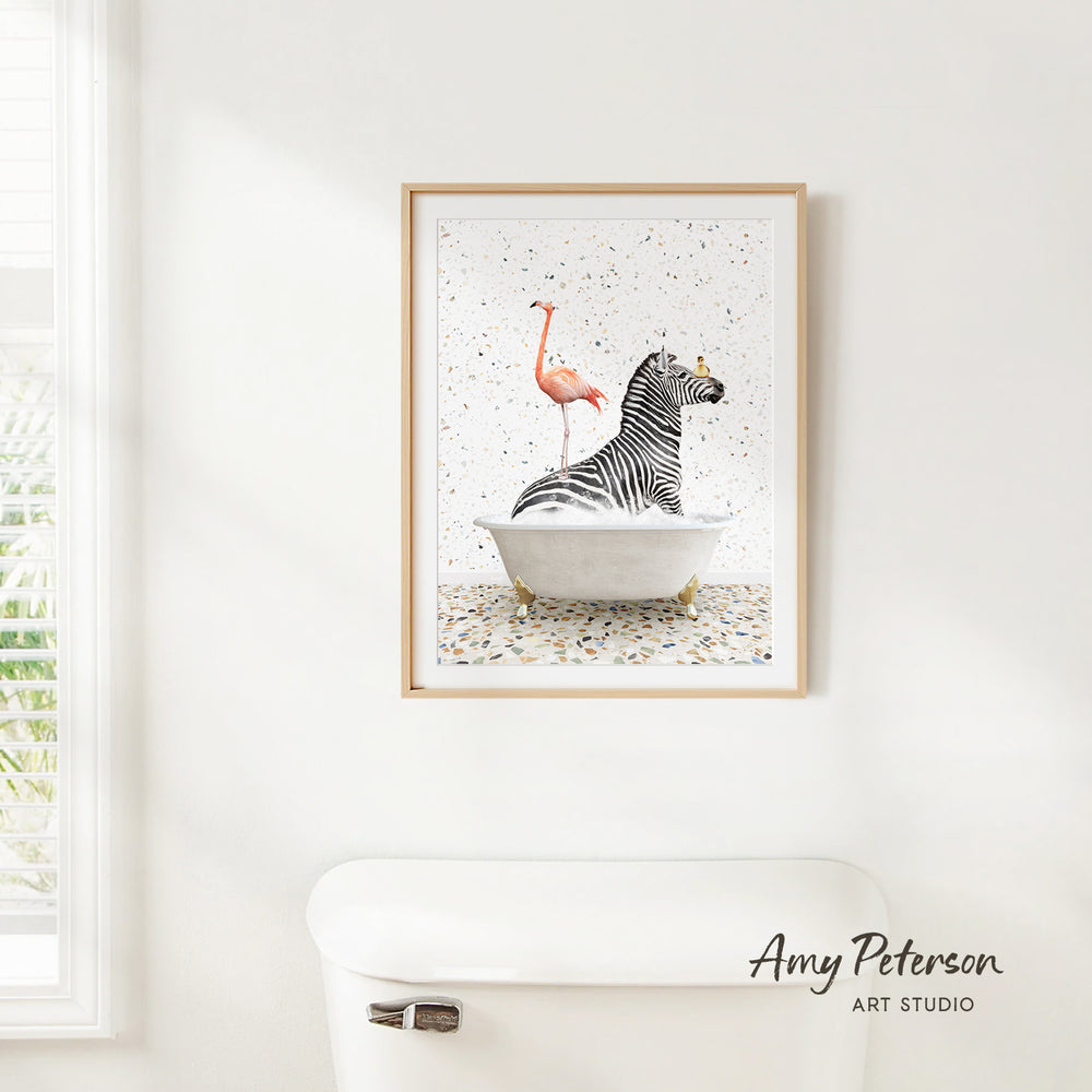 A framed painting of a zebra sitting in a bathtub, with a pink flamingo standing on one leg in the background.