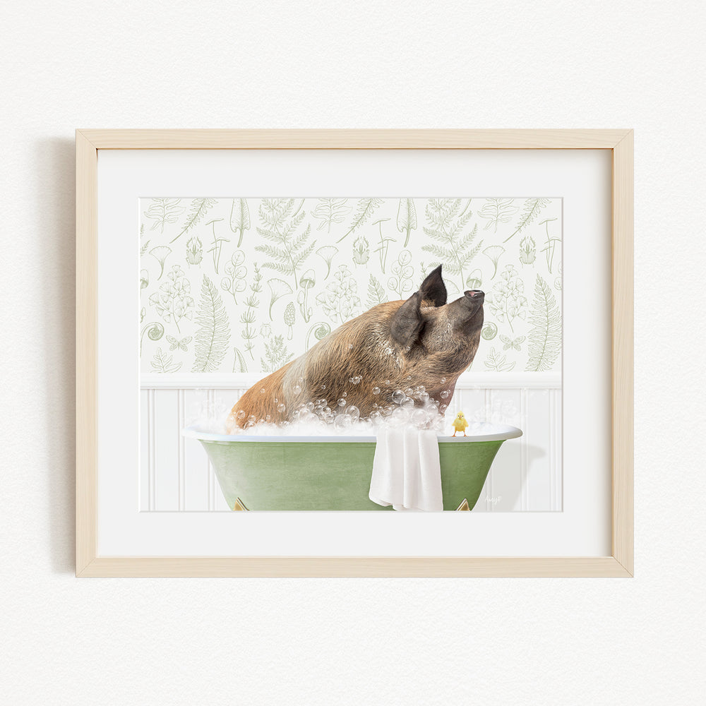 A brown pig sitting in a green bathtub filled with bubbles, with a towel draped over the side of the tub.