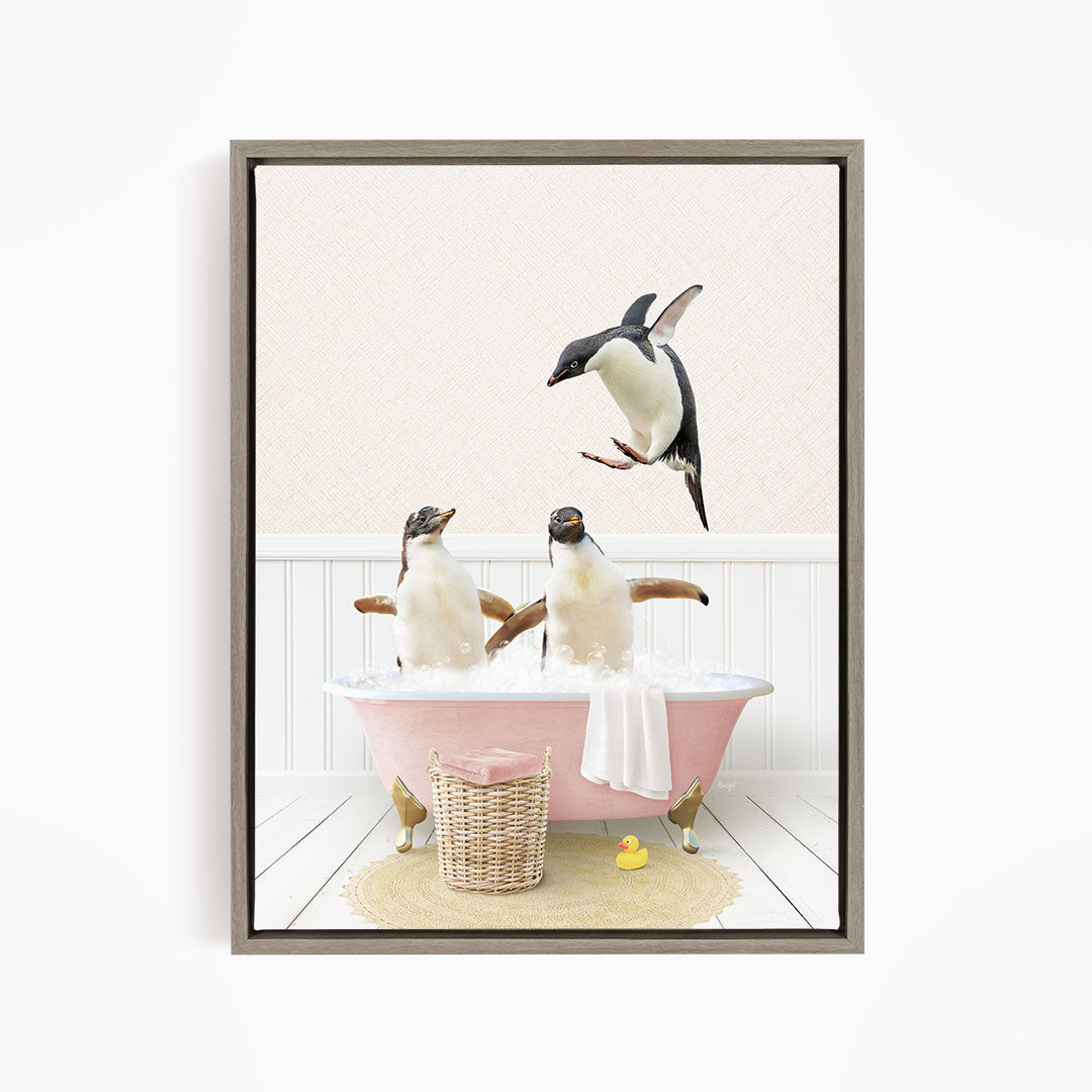 A framed image depicting two penguins sitting in a pink bathtub, with one penguin flying towards the other.
