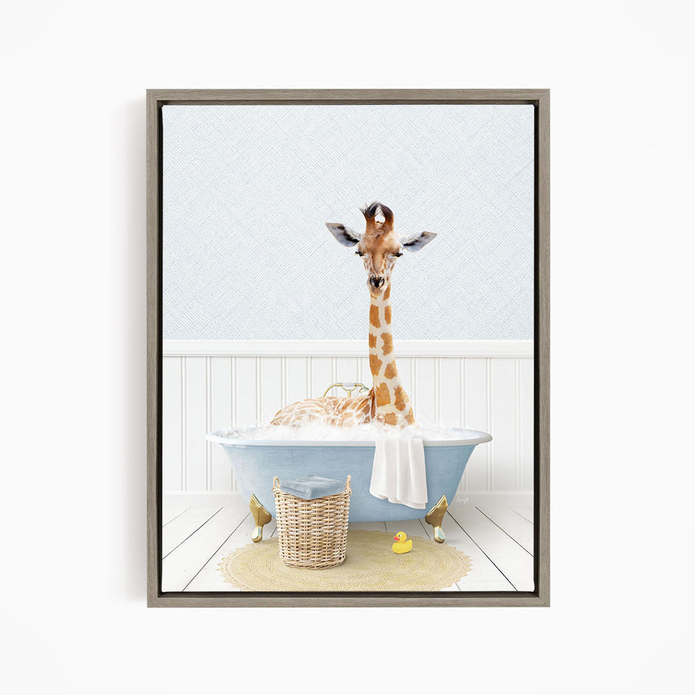 A giraffe sitting in a blue bathtub filled with bubbles, surrounded by a basket of toys and a yellow rubber duck.