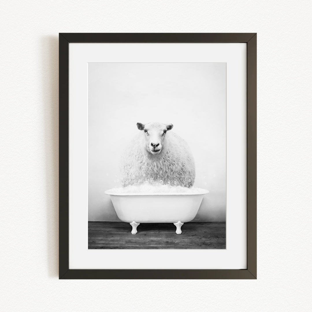 A fluffy white sheep sits in a white bathtub, creating a whimsical and amusing scene.