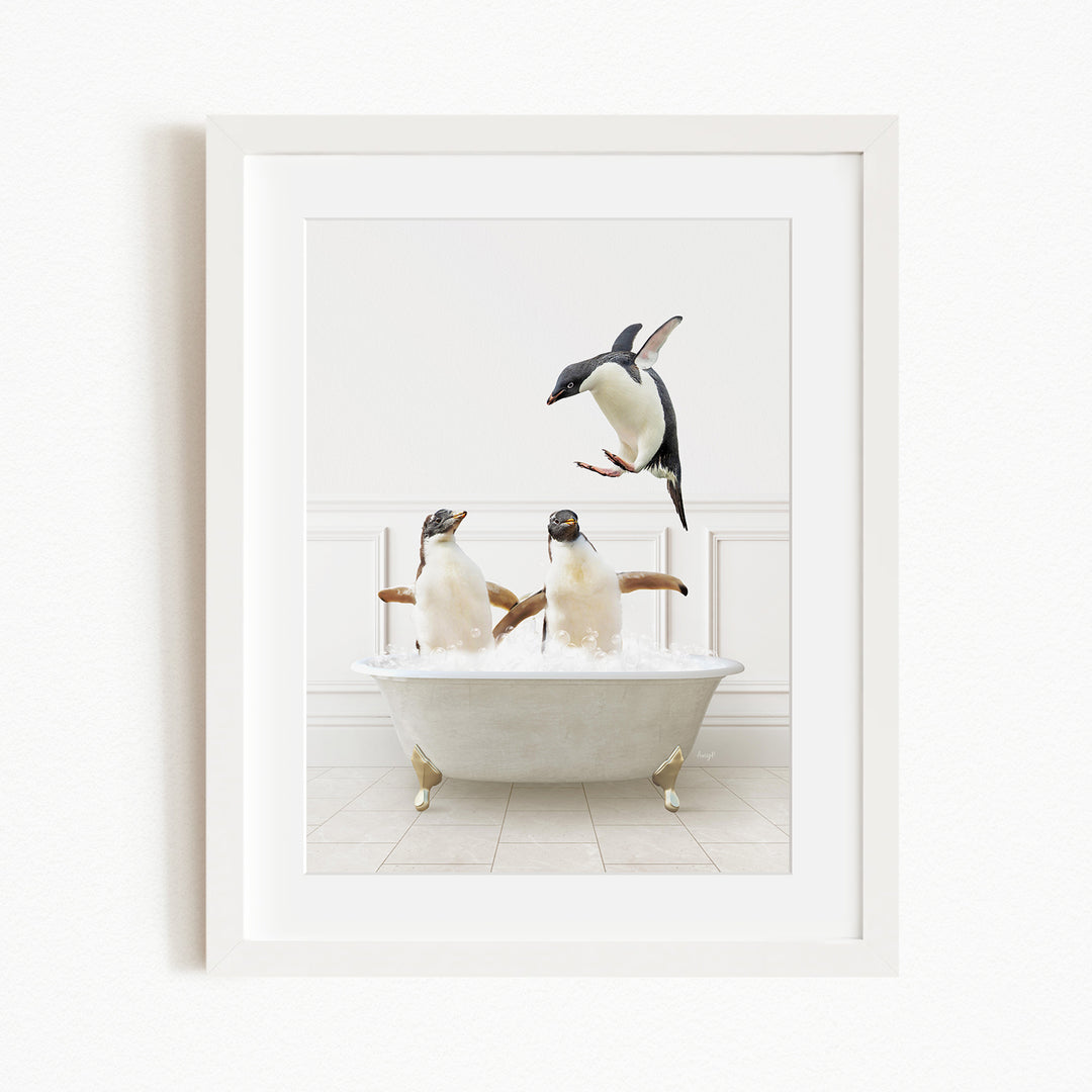 A framed image depicting two penguins sitting in a bathtub, with one penguin flying towards the other penguin.