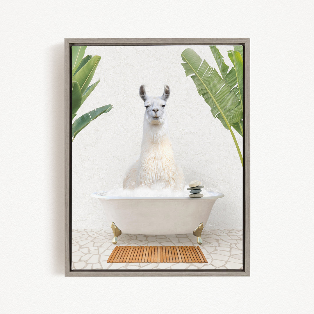 A white llama sitting in a white bathtub filled with bubbles, surrounded by green plants and a wooden mat on the floor.