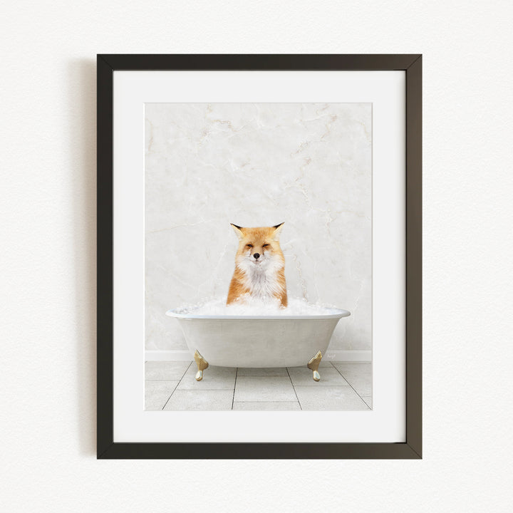 A framed image of a fox sitting in a white bathtub filled with bubbles.