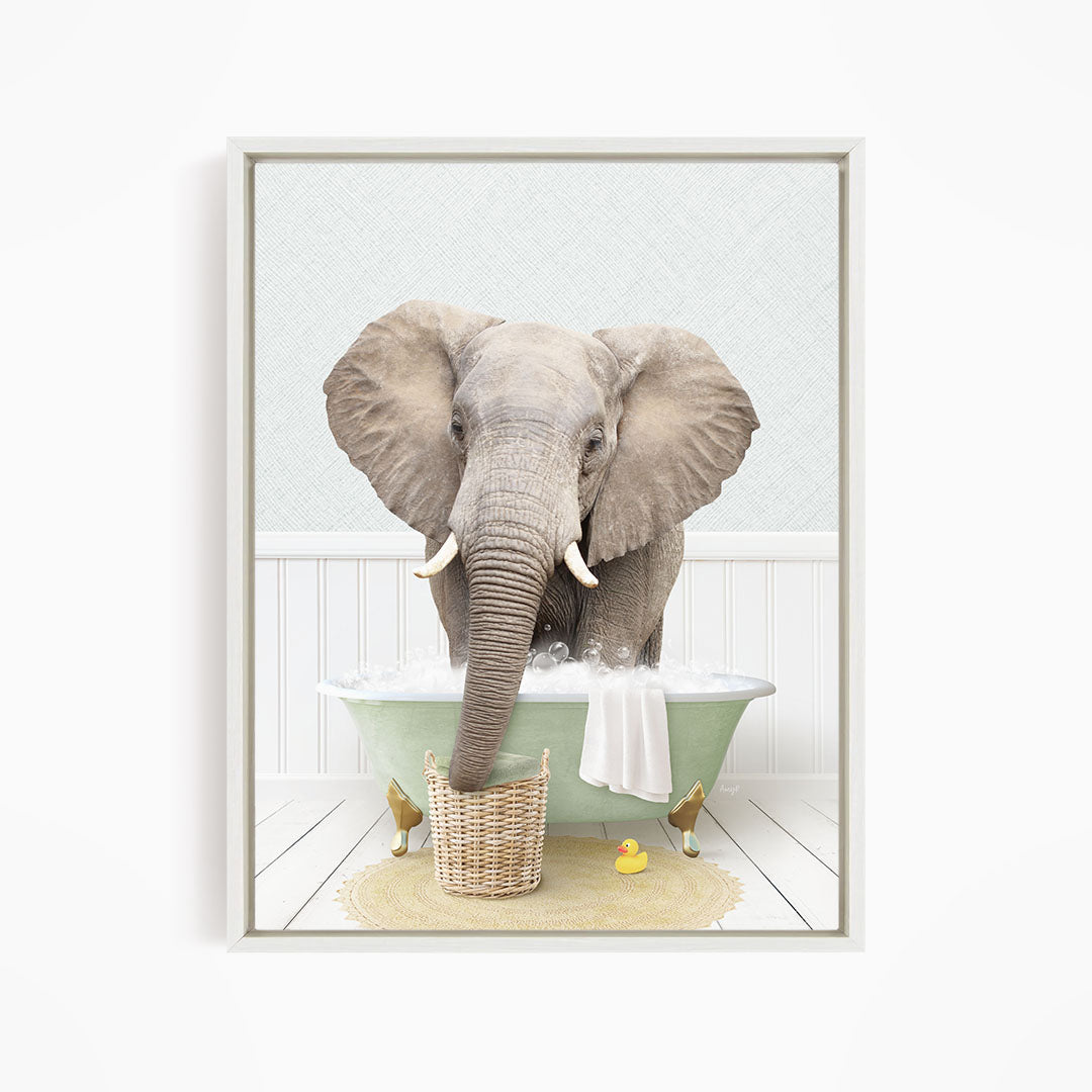 A gray elephant is standing in a green bathtub filled with water, surrounded by rubber ducks.