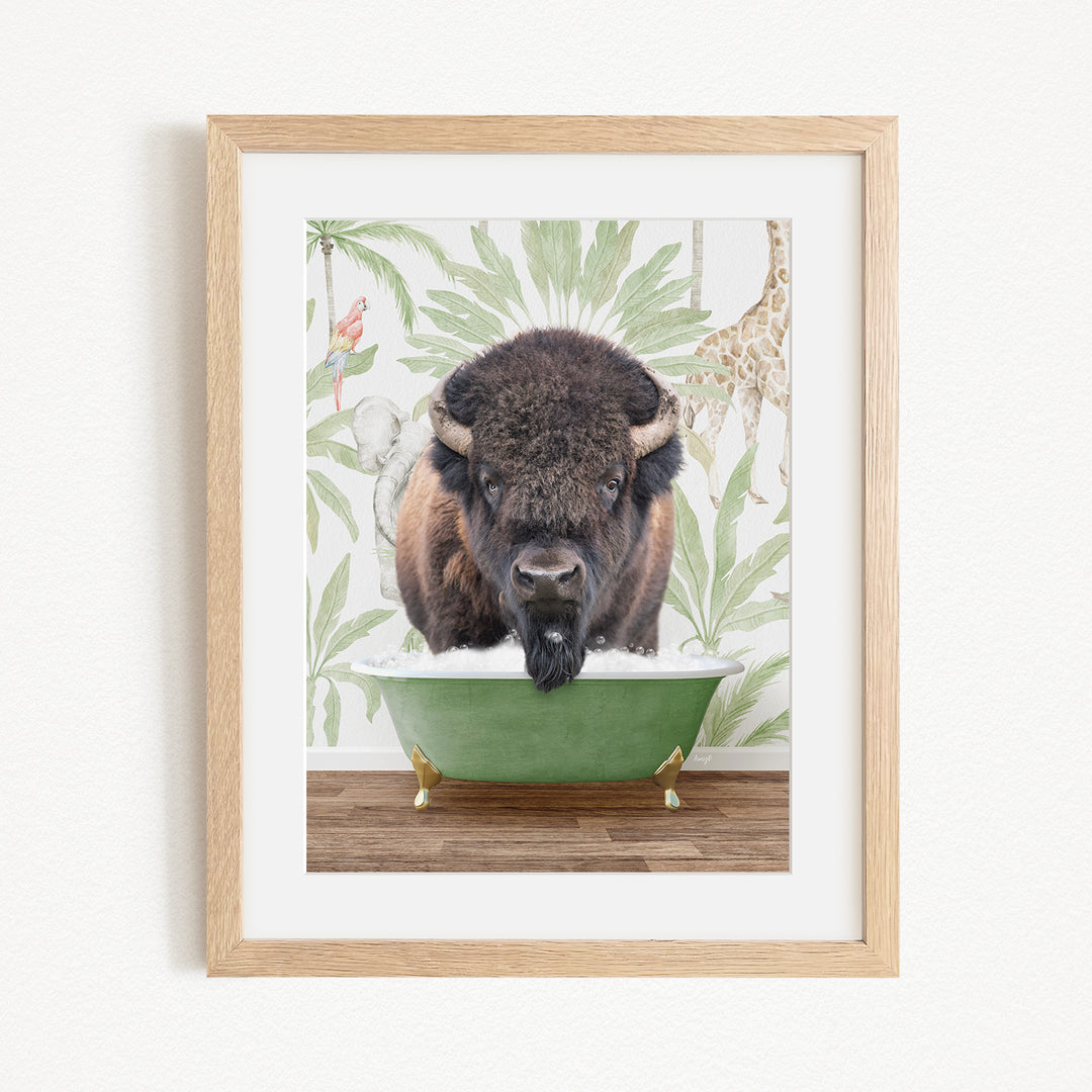 A framed image depicting a bison with a giraffe in the background, both in a green bathtub.