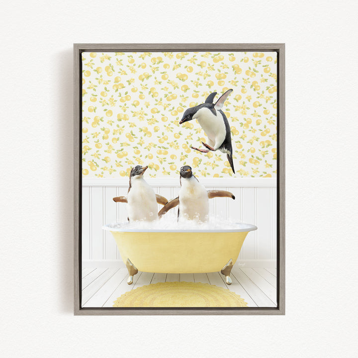A framed image depicting two penguins sitting in a yellow bathtub, with one penguin flying towards the other in mid-air.