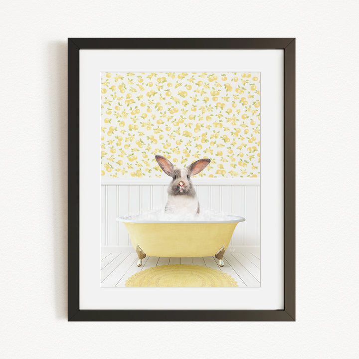 A rabbit sitting in a yellow bathtub filled with bubbles, surrounded by a yellow floral wallpaper.