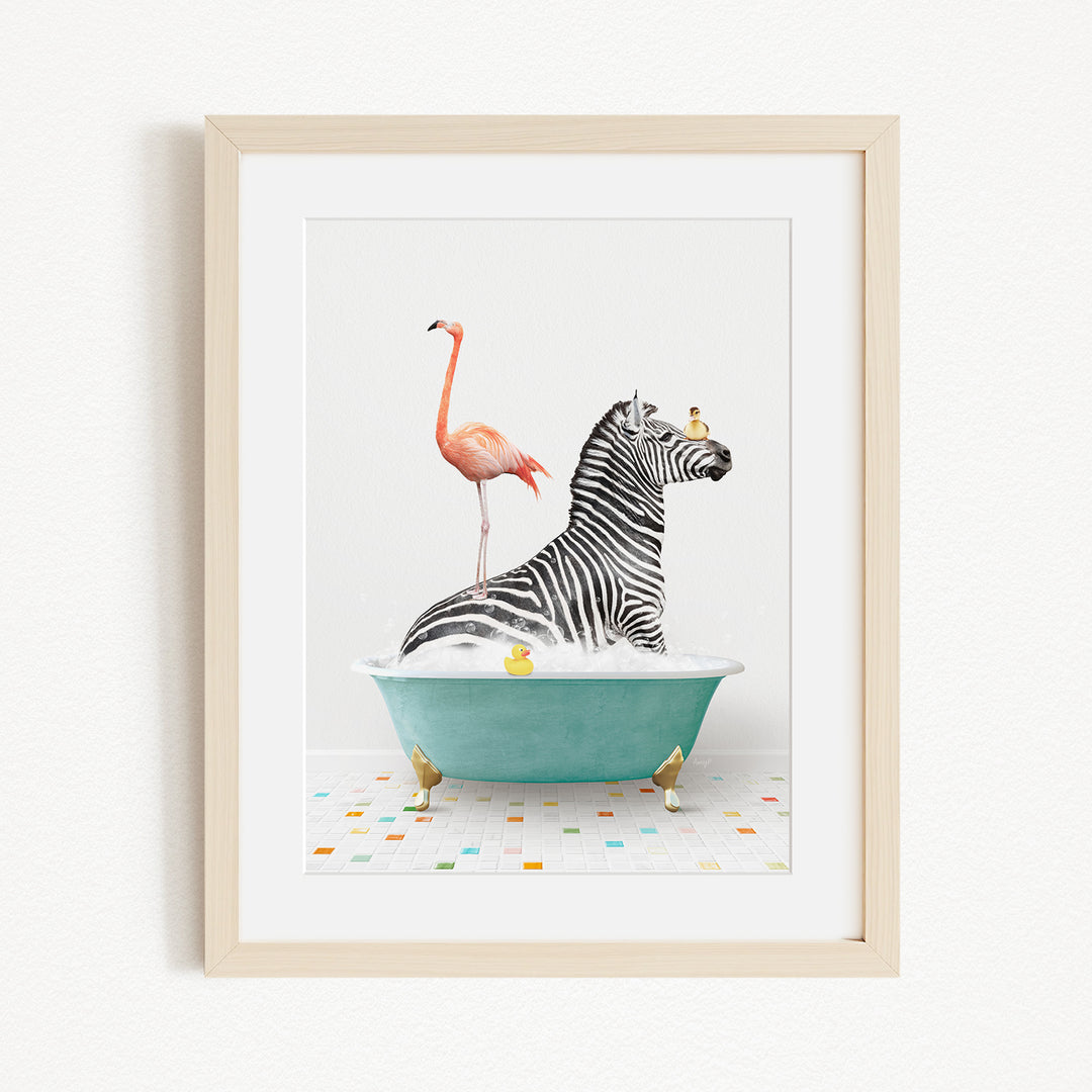 A framed image depicting a zebra standing in a bathtub filled with bubbles, with a flamingo standing on one leg and a bird perched on the zebra's head.