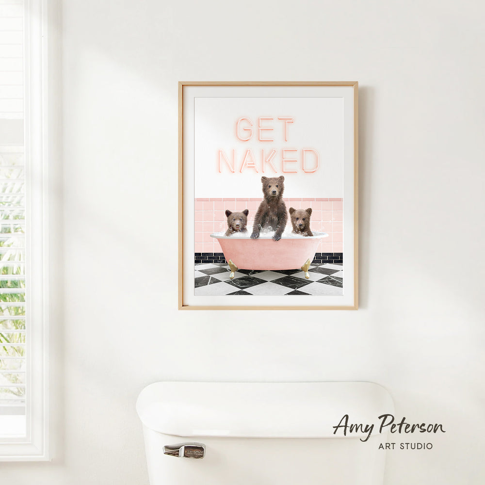A framed print with the text "GET NAKED" and an illustration of three bears sitting in a bathtub.