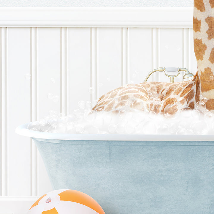 a giraffe laying in a bathtub with foam