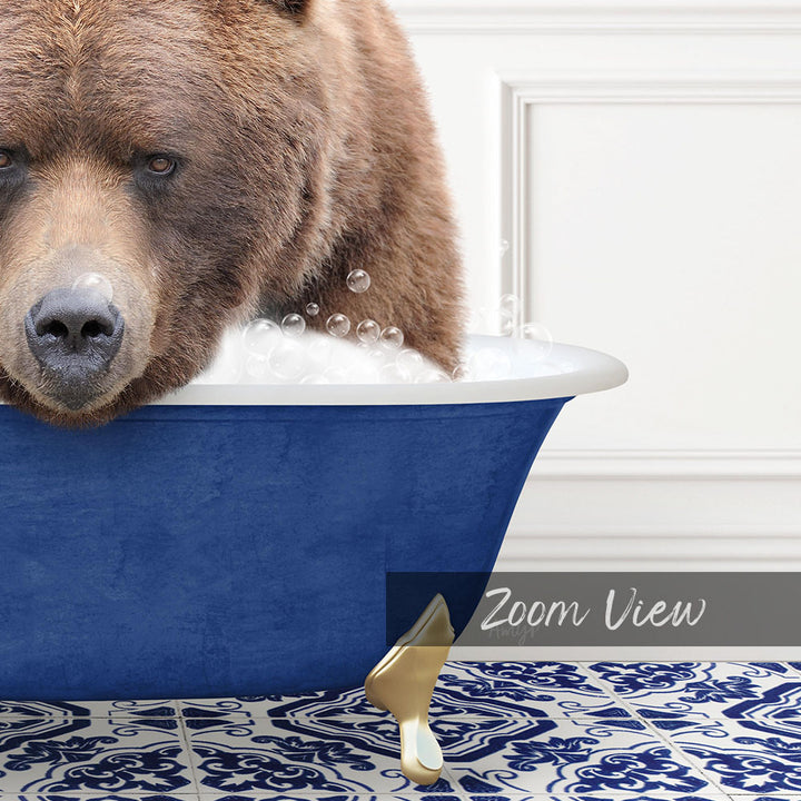 A large brown bear is sitting in a blue bathtub filled with bubbles, creating a whimsical and playful scene.