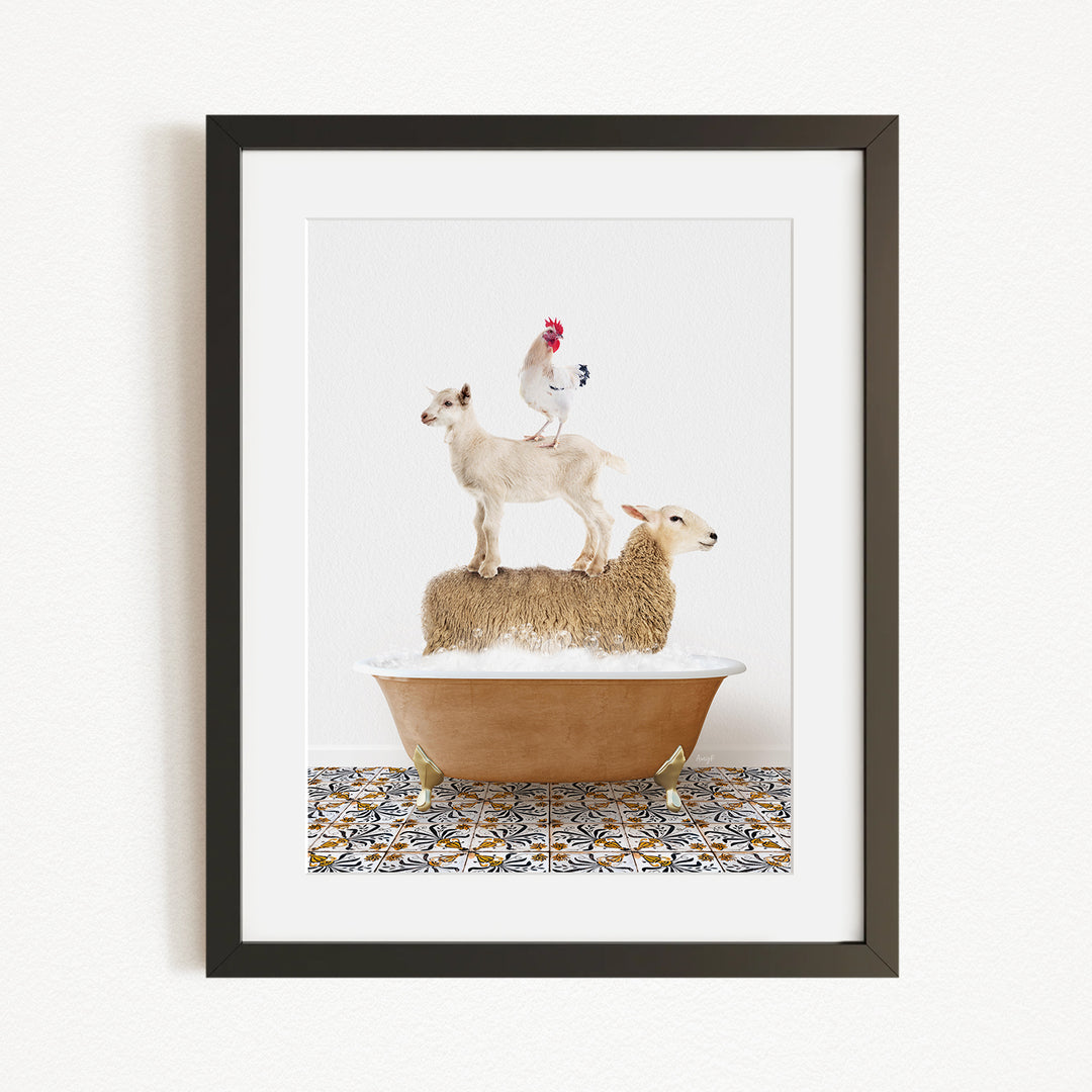 A framed image depicting a goat standing on a sheep's back while a rooster stands on top of a sheep in a bathtub.