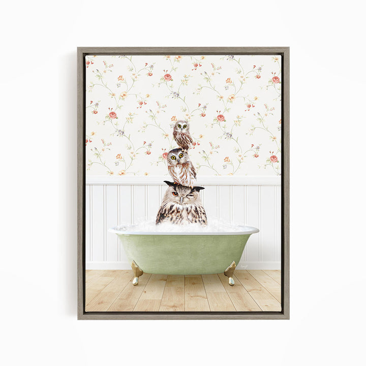 A framed image depicting three owls sitting in a green bathtub, with a floral wallpaper in the background.