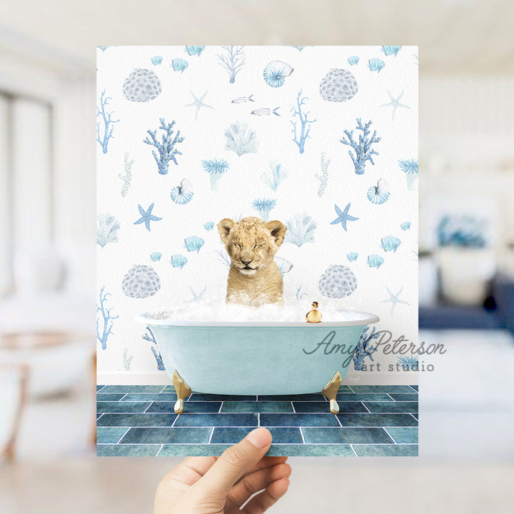 a hand holding up a card with a picture of a baby lion in a bath