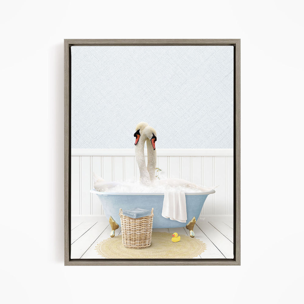 A pair of swans sitting in a blue bathtub filled with bubbles, surrounded by a basket of toys and a yellow rubber duck.