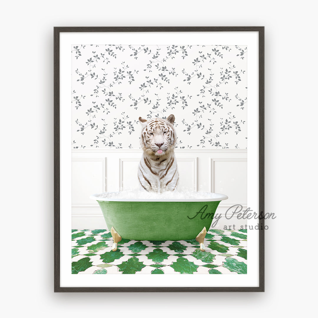 a white tiger sitting in a green bath tub