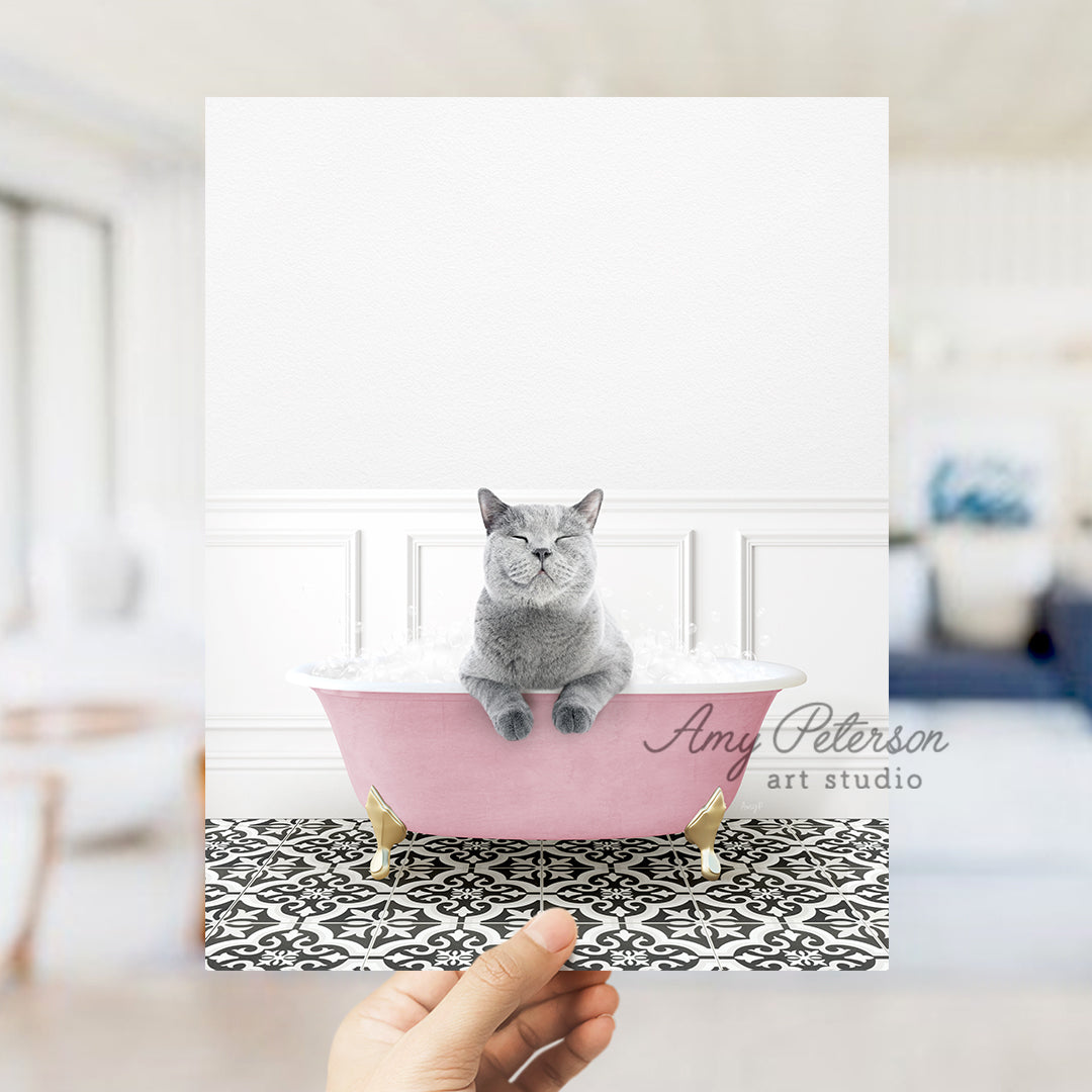 a person holding a card with a cat in a bathtub