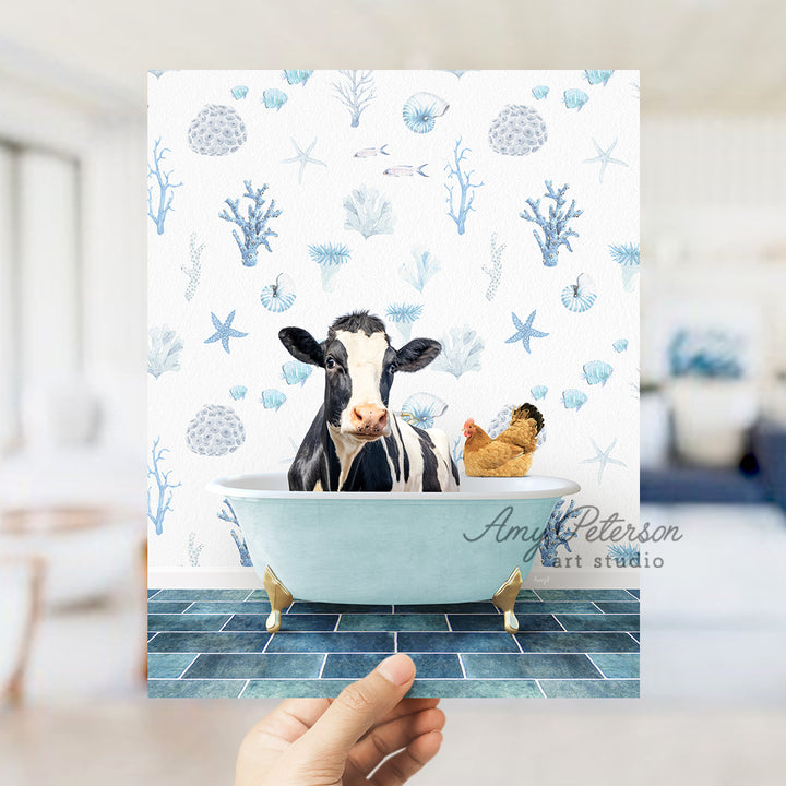 a hand holding up a card with a picture of a cow in a bathtub