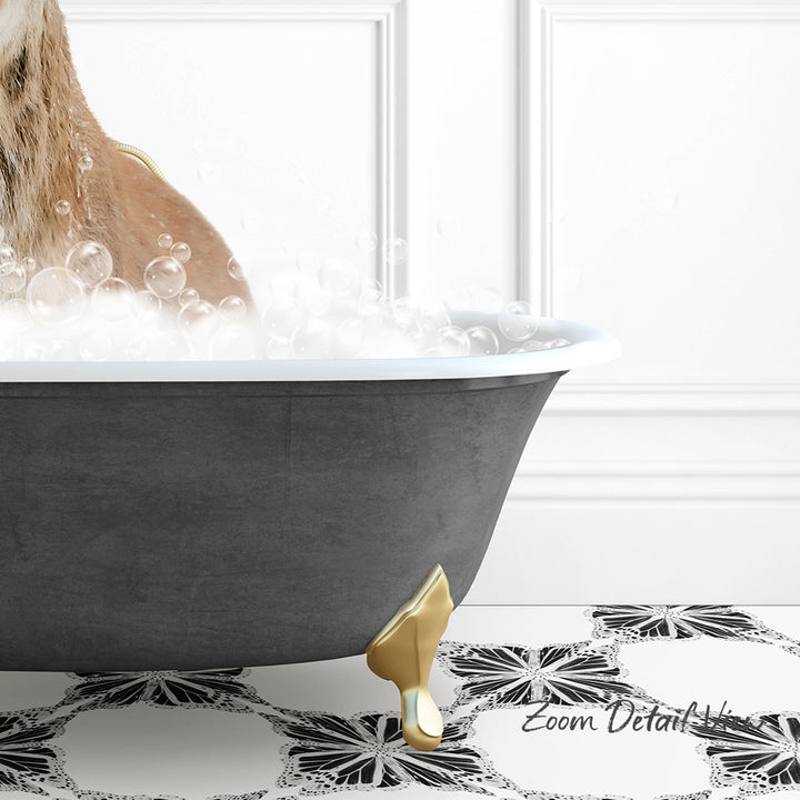 A dog is sitting in a bathtub filled with bubbles, with a gold claw-like object on the side of the tub.