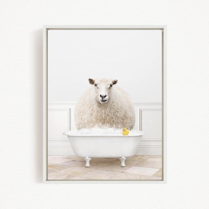 A fluffy white sheep sits in a white bathtub, with a yellow rubber duck floating on the water.