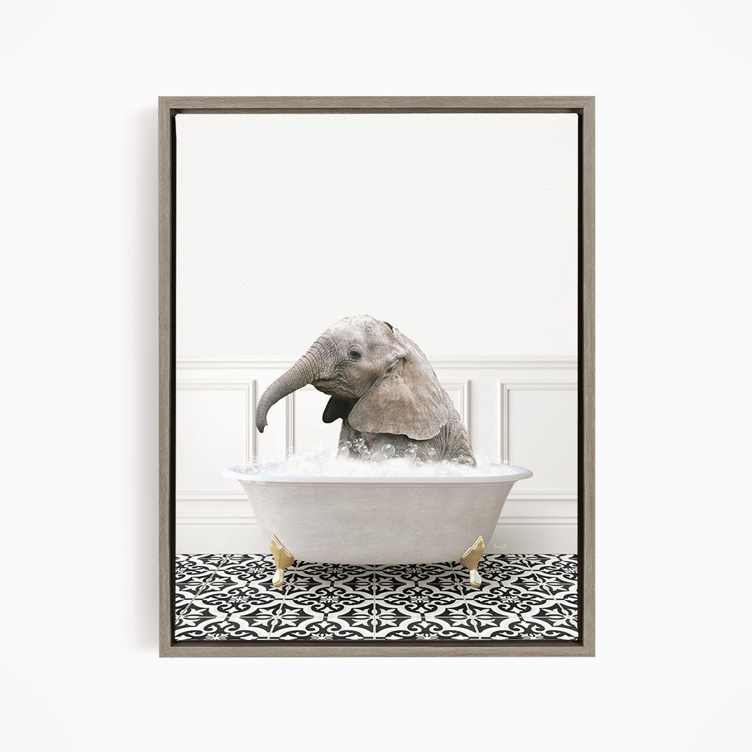 A baby elephant sitting in a white bathtub filled with water, surrounded by a black and white patterned floor.