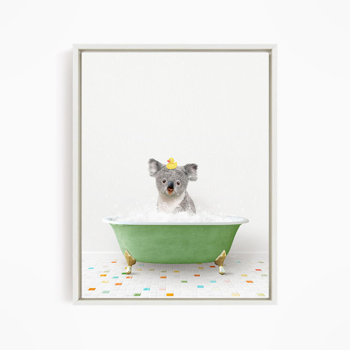 A koala bear sitting in a green bathtub filled with bubbles, wearing a yellow rubber duck hat.