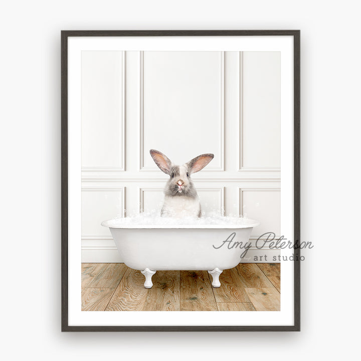 a rabbit sitting in a bathtub with his ears sticking out