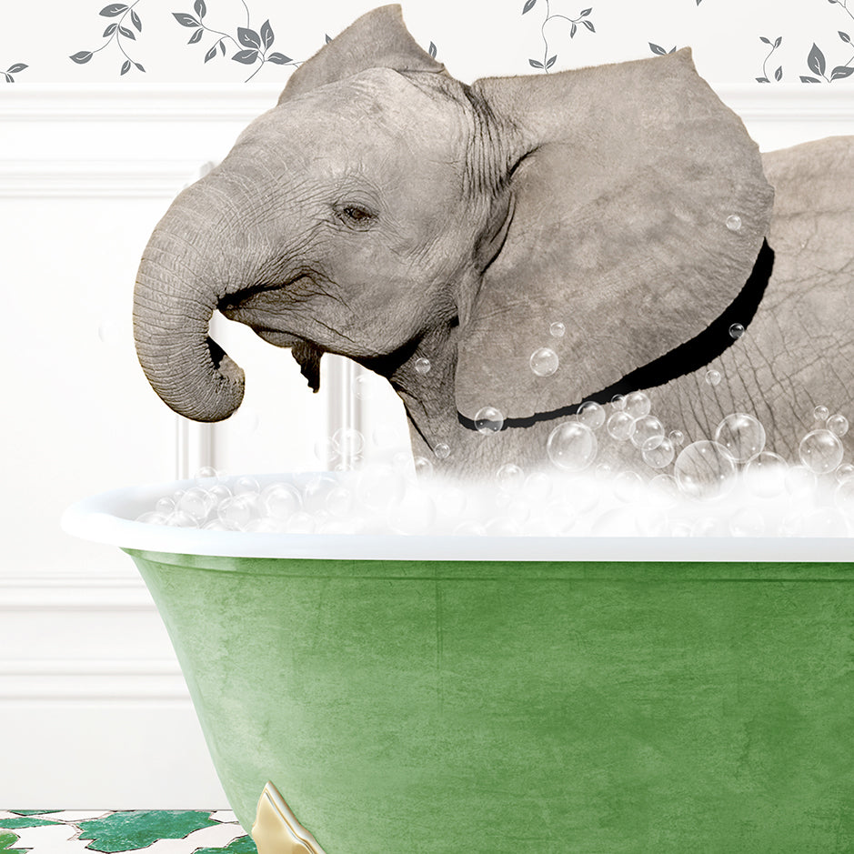 a baby elephant taking a bath in a green tub