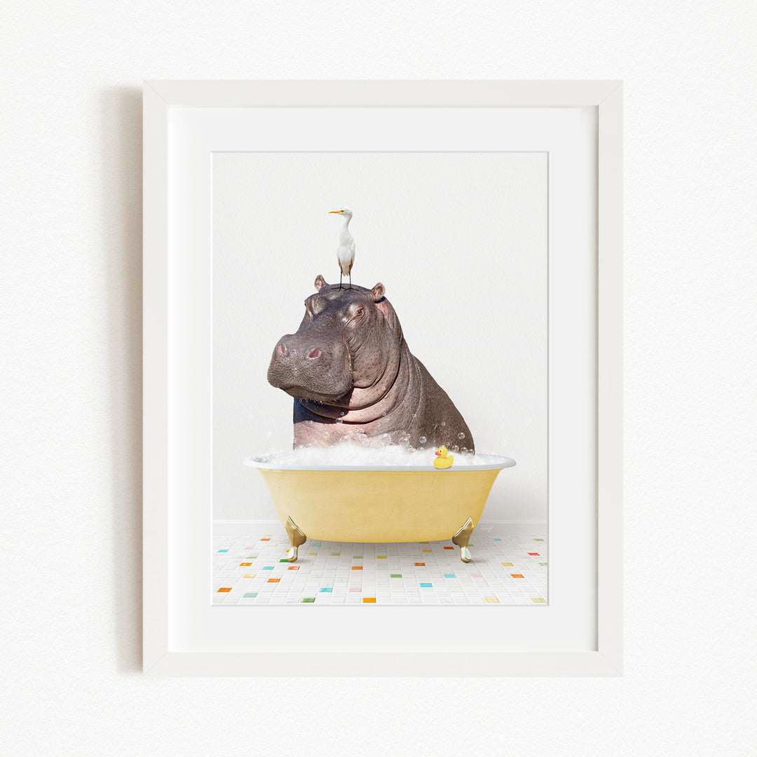 A framed image depicting a hippopotamus sitting in a yellow bathtub, with a bird perched on its head.