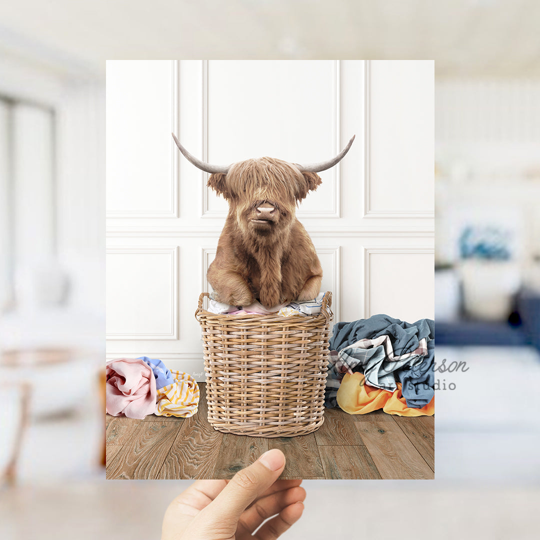 a hand holding a photo of a dog in a basket