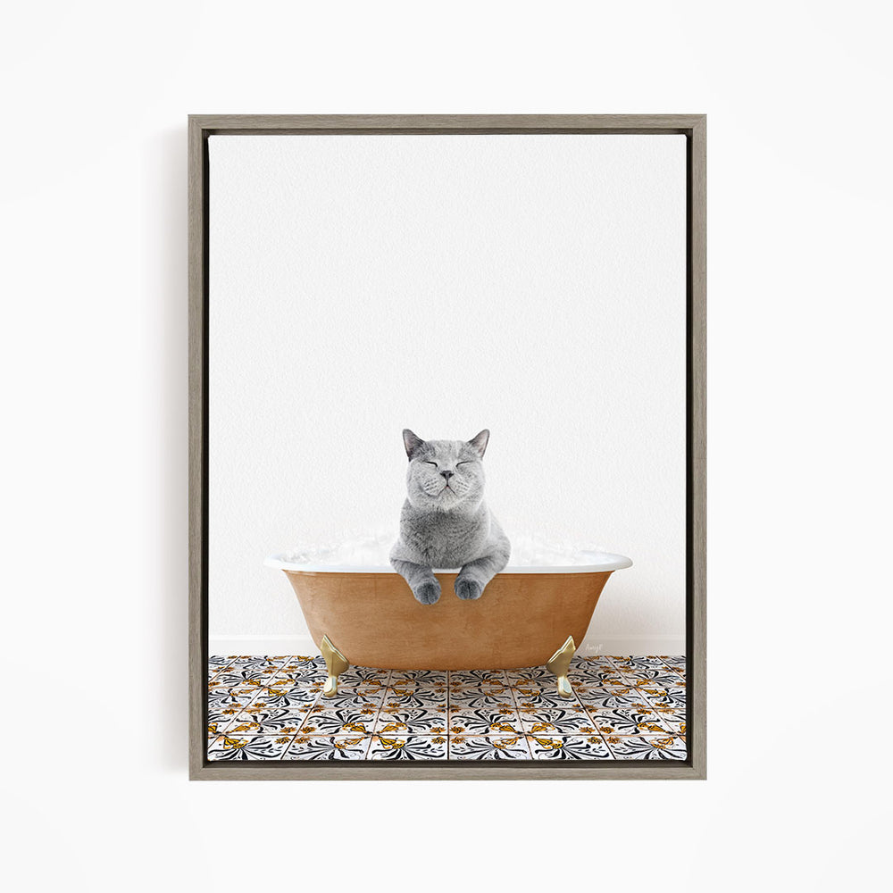 A gray cat sitting in a bathtub filled with bubbles, with a patterned tile floor beneath it.
